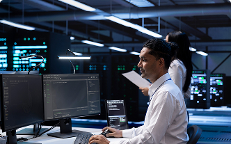 A man working on a computer in a tech facility