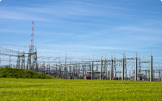 A field with high voltage power transmission towers and power lines