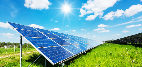 Solar panels in a field on a bright sunny day